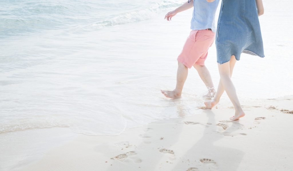 海を歩くカップル